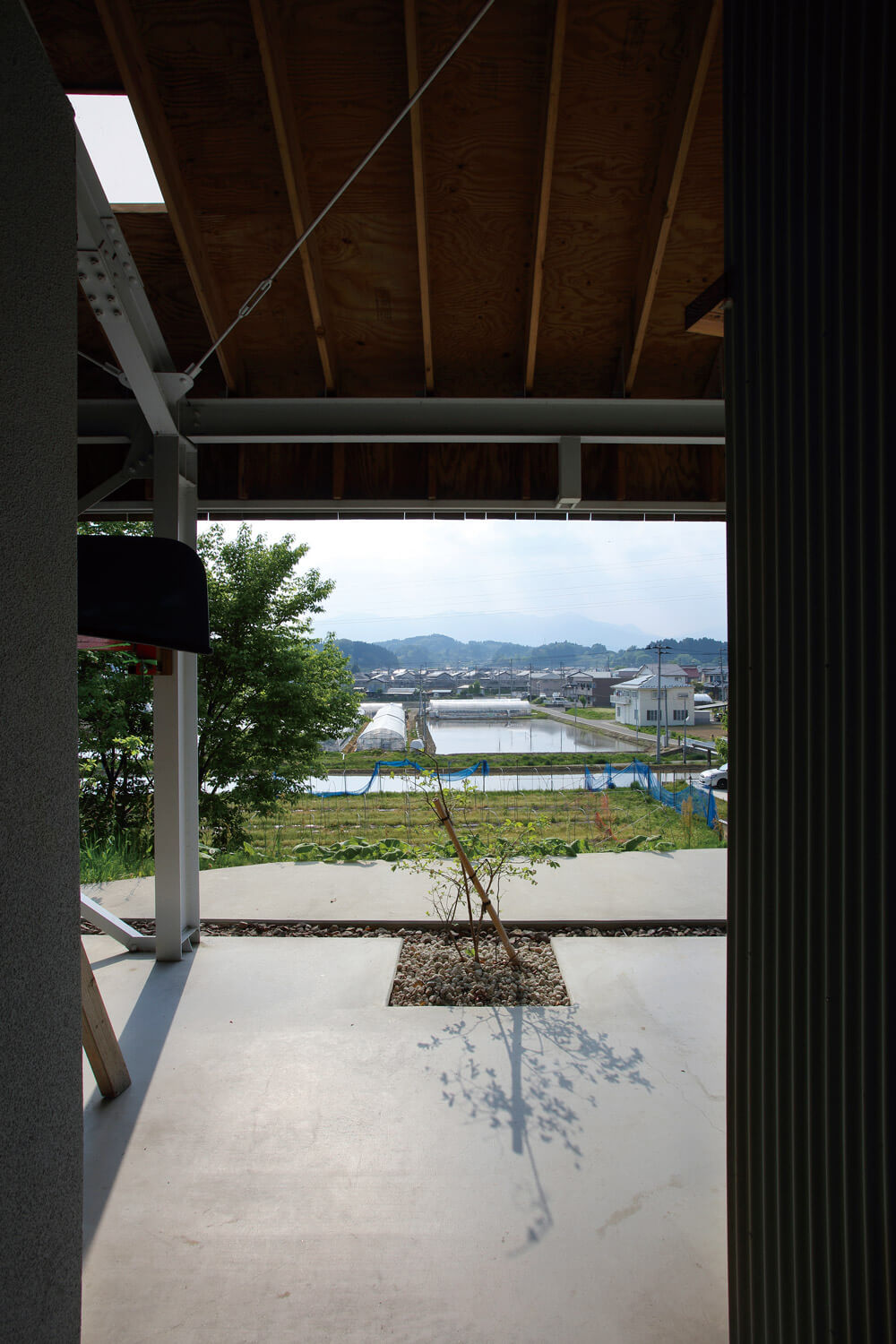 大屋根の下から、地元の田畑や民家の向こうにそびえる雄大な安達太良山が望める