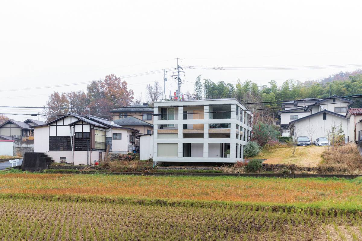 田んぼと竹林が広がる古い集落の一角にあるHさん宅。西側からは、総2階建てのように見える