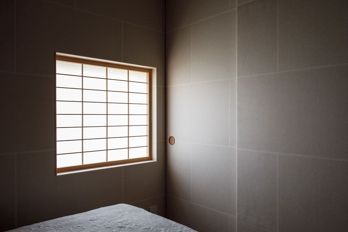 寝室は和紙で有名な美濃の紙を壁に使って柔らかなニュアンスに。障子を通して射し込む光の陰影が美しい