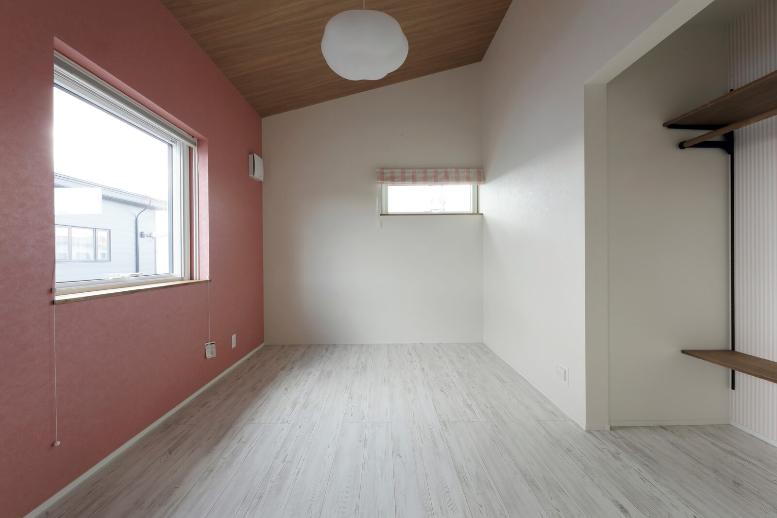 勾配天井が印象的な2階の子ども部屋。収納には扉を設けず、見せる収納を提案