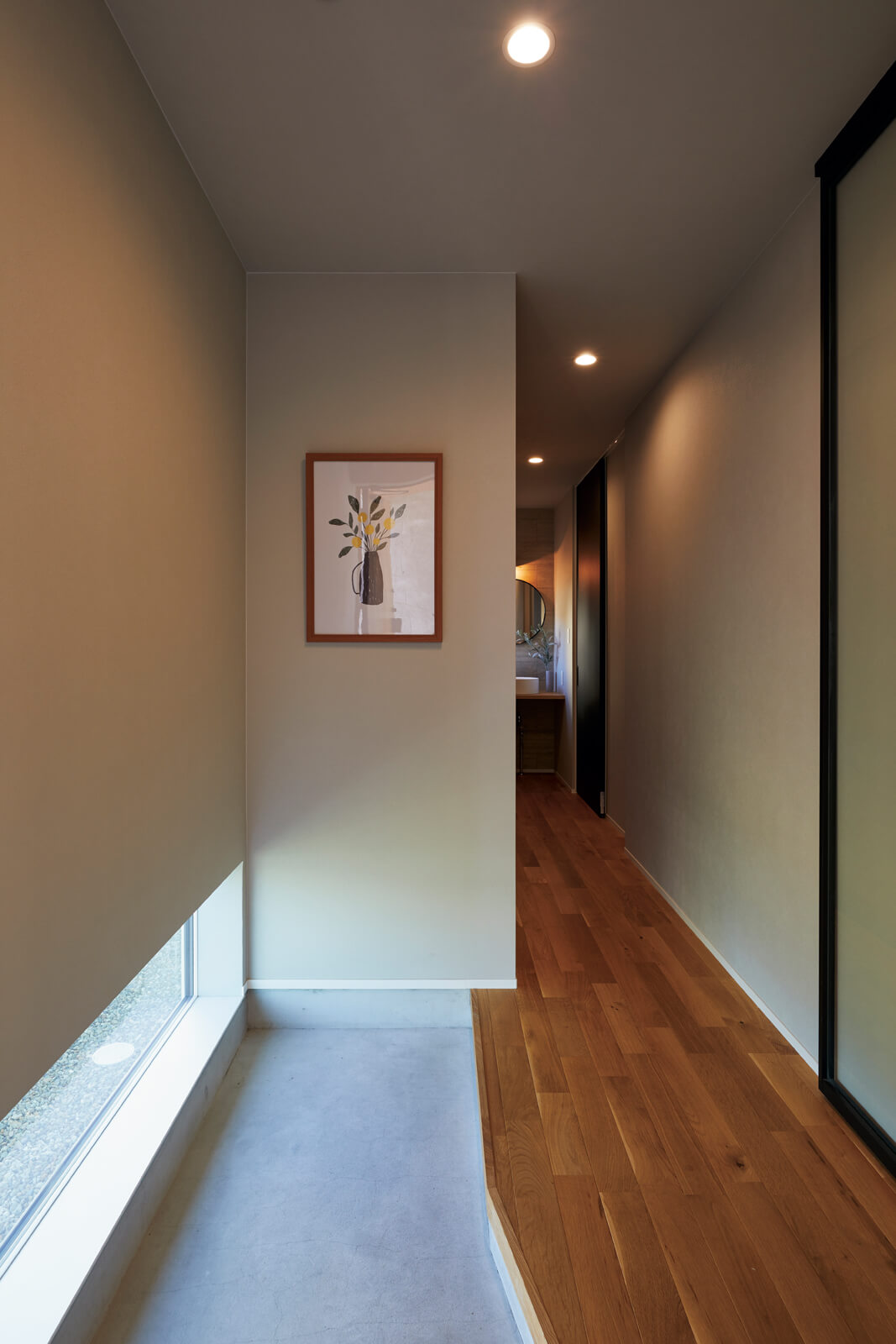 玄関ホールは地窓で採光を確保。リビングへの表動線と廊下を介してキッチンに通じる裏動線が設計されている