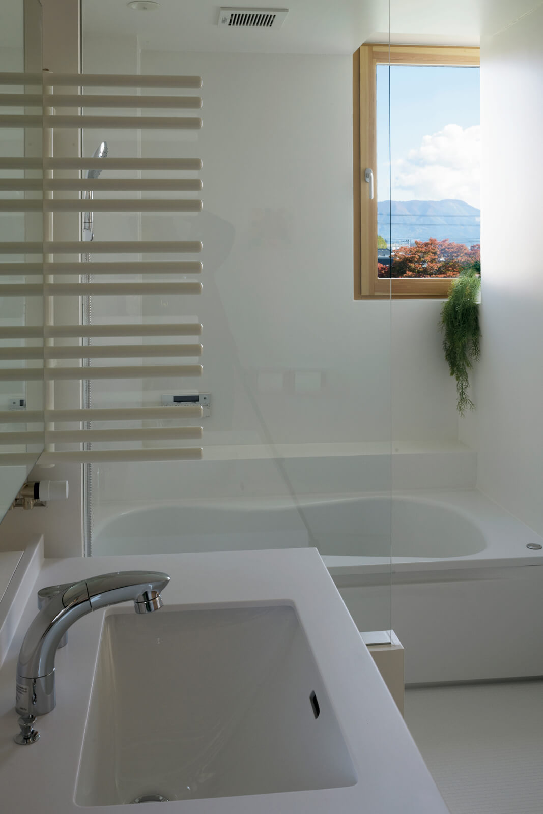 浴室にも川を望む木製窓。洗面室にはタオルを乾かせるパネルヒーターを備えた