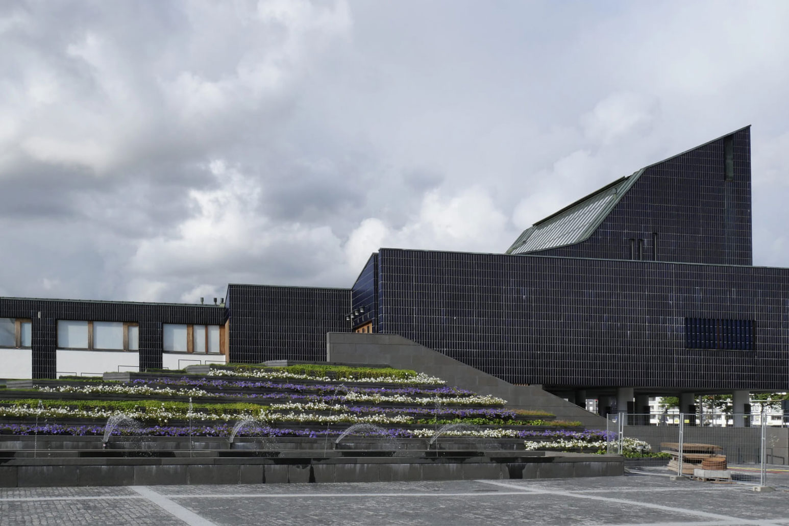 裏手には階段を兼ねる緑化スペースが組み込まれていて、建築と自然の一体感が感じられる