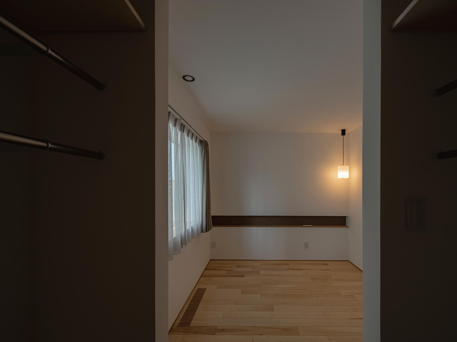 水まわりの奥に寝室と子ども部屋がレイアウトされている。寝室は、造作ニッチと照明を組み合わせホテルライクな雰囲気に